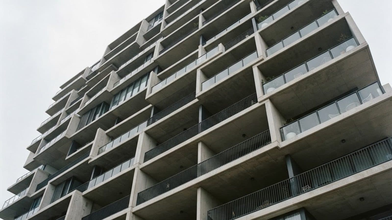 Layered concrete balconies of a modern Australian apartment building seen from below